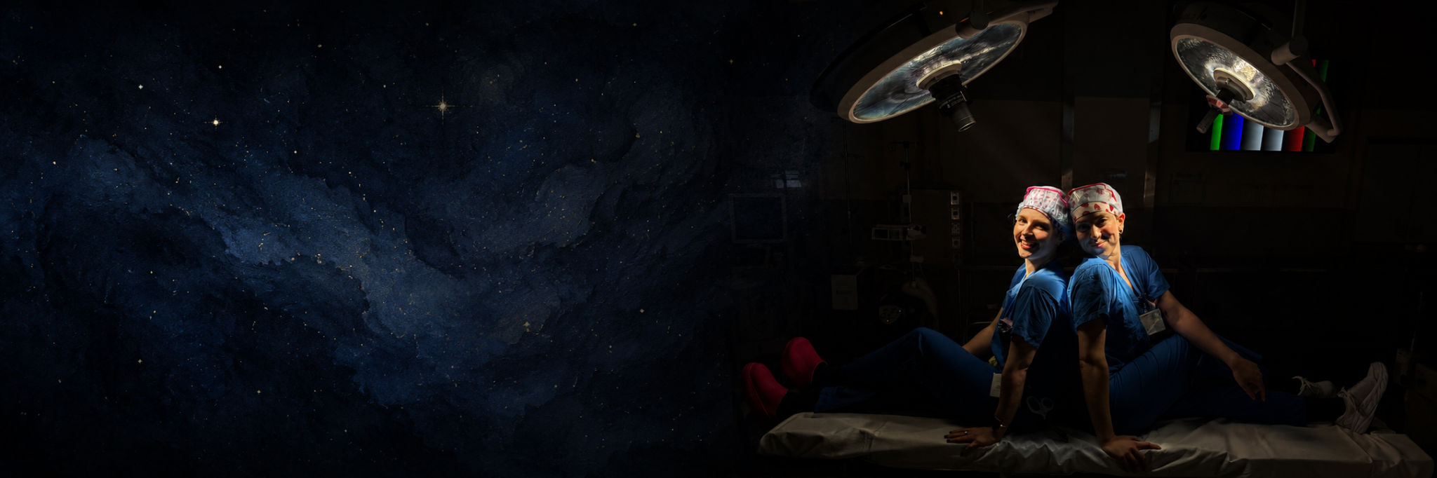 Two surgical team members seated beneath operating room lights