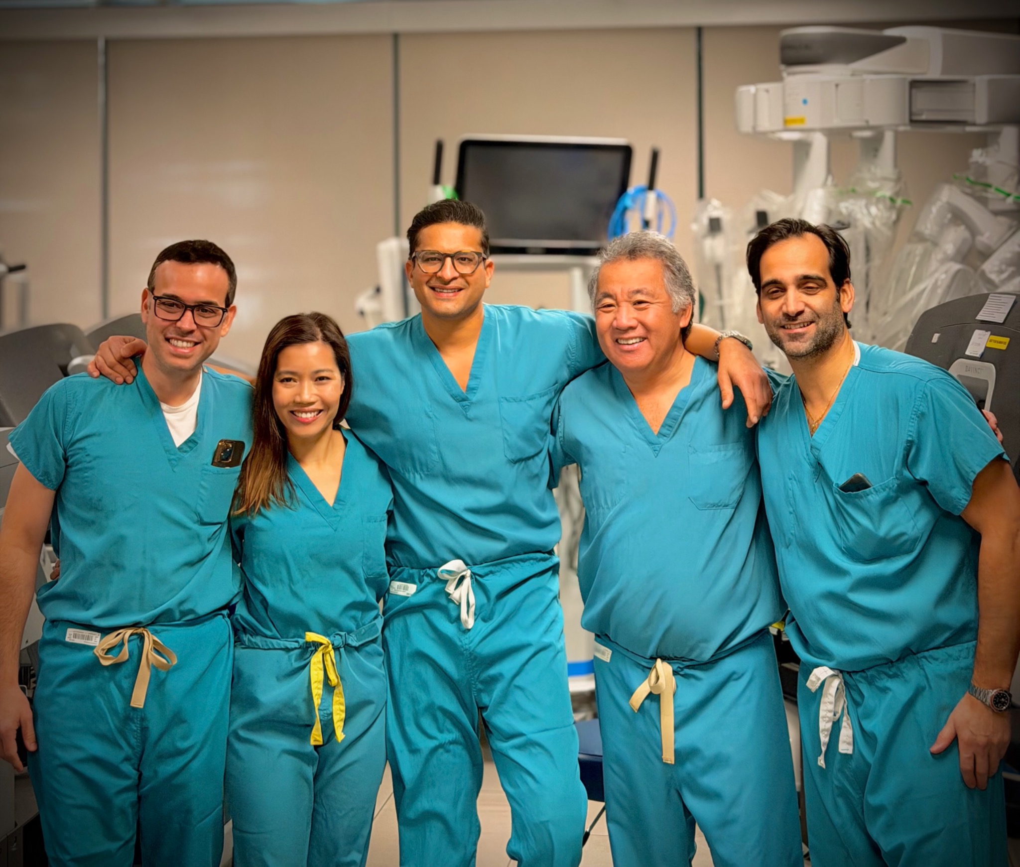 Five robotic transplant surgeons together in scrubs representing the kidney masterclass
